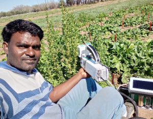 Person in field with LI-6800 Portable Photosynthesis System